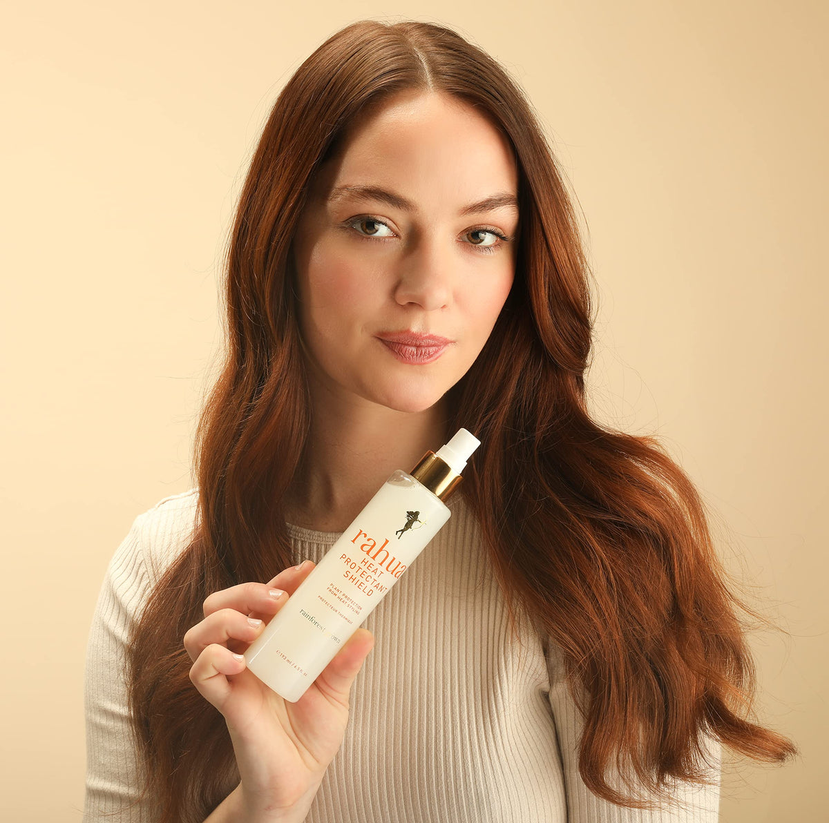 Rahua spray being applied while blow-drying to show styling protection and reduced damage benefit