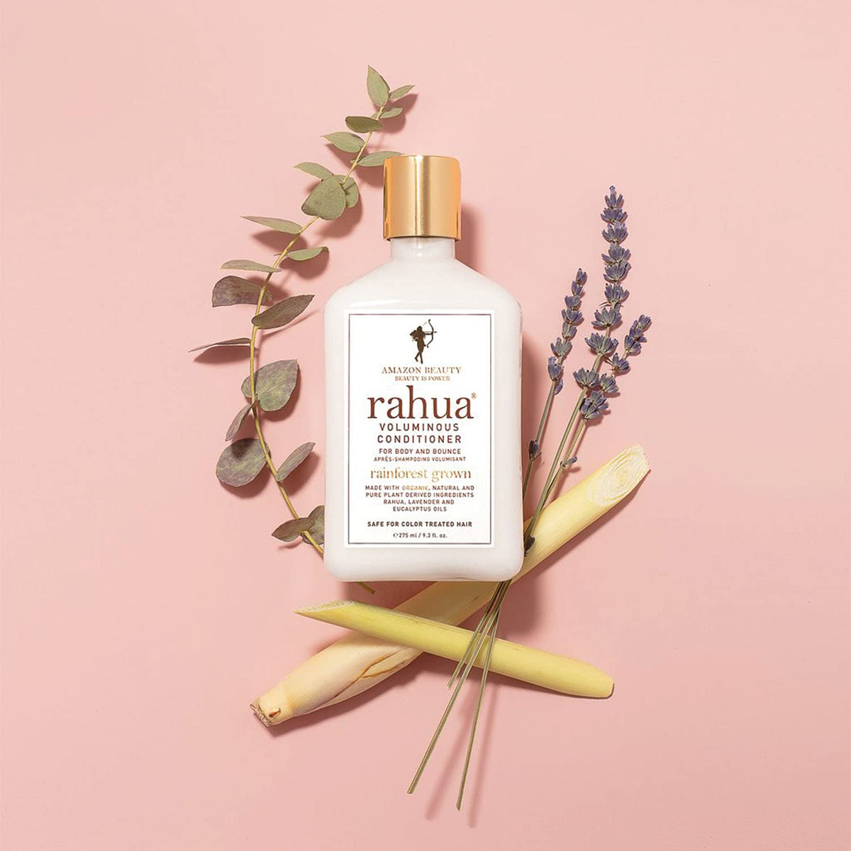 Rahua bottle held next to hand to indicate 9.3 fl oz scale and travel convenience