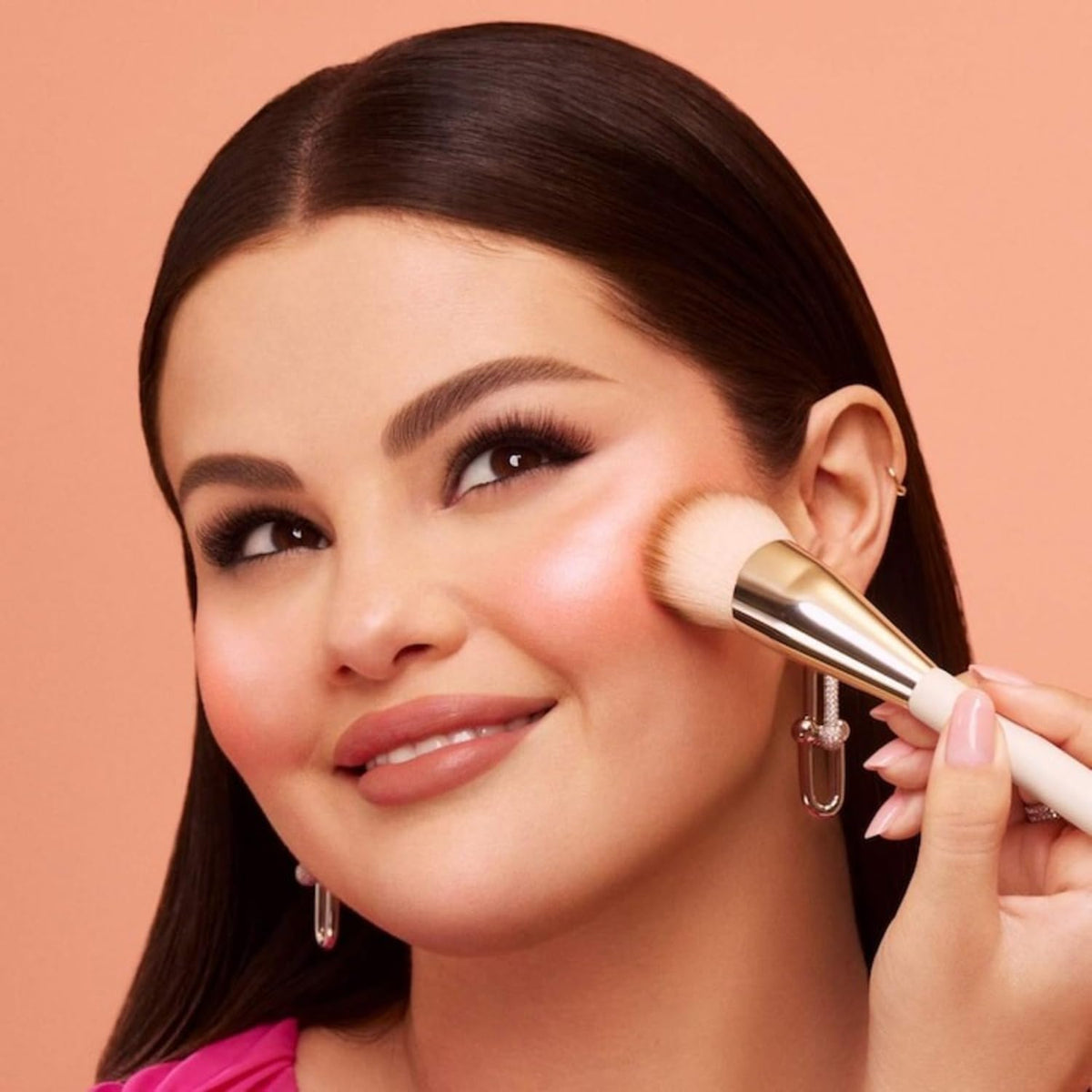 Rare Beauty Cheer being swiped with a brush for even application and control