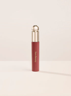 Rare Beauty bottle front view showing sleek packaging and glossy tint benefit