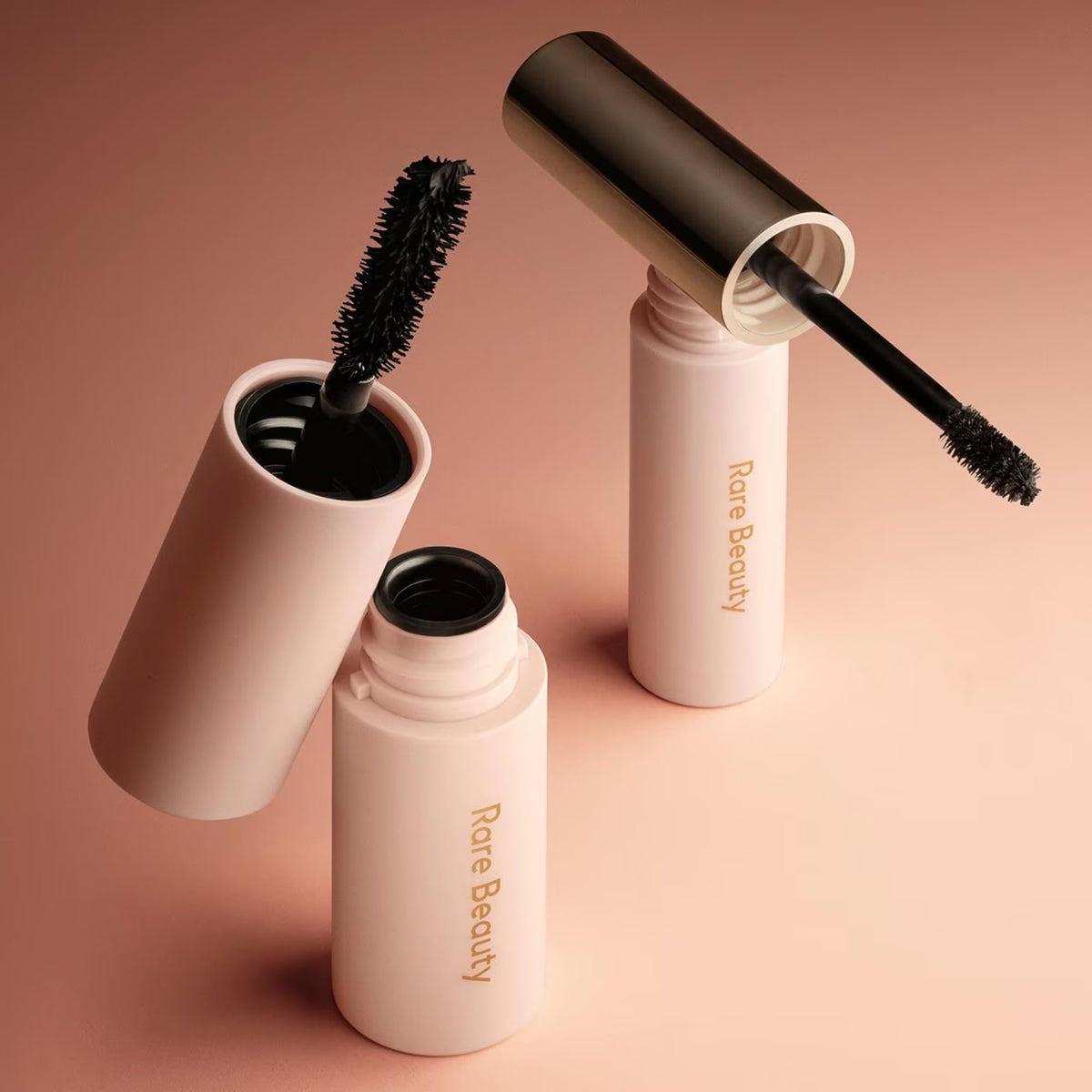 Rare Beauty mini set beside common items showing compact, travel-friendly size