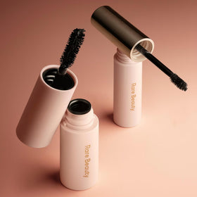 Rare Beauty mini set beside common items showing compact, travel-friendly size