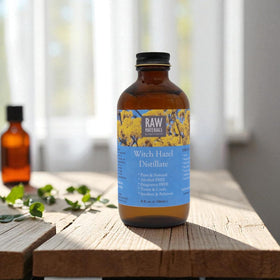 RAW MATERIALS bottle held in hand showing 8oz scale and travel-friendly, eco glass benefit