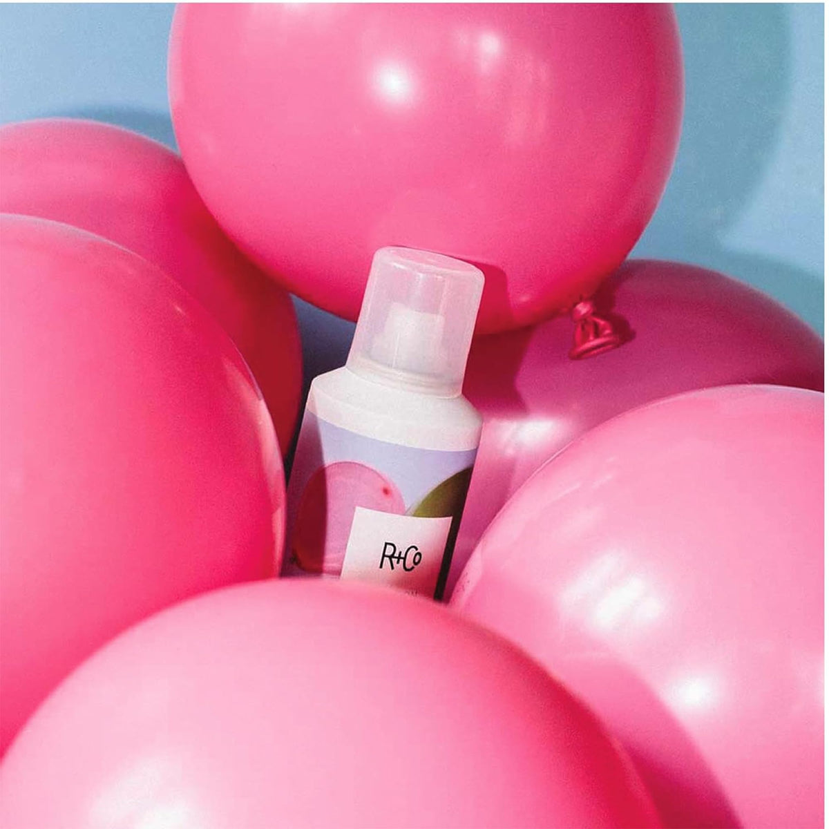 R+Co nozzle close-up highlighting fine mist for even, weightless hold