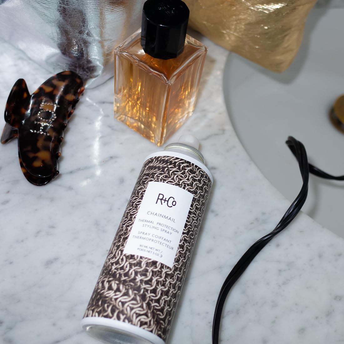 R+Co Chainmail ingredients visual display with oils and extracts boosting smoothness