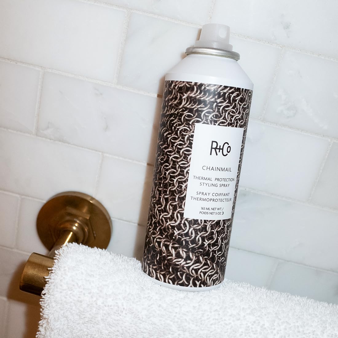 R+Co Chainmail size comparison 5 oz bottle showing travel-friendly, salon-quality benefit
