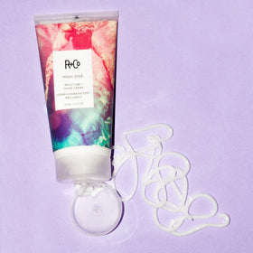 R+Co HIGH DIVE held in hand to show 50 ml size and travel-friendly benefit