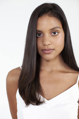 R+Co Moon Landing misting on styled hair demonstrating humidity protection and smooth finish