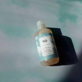 R+Co shampoo being applied in shower demonstrating gentle cleansing