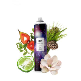 R+Co Outer Space next to a hand showing 9.5 oz scale for travel-friendly use