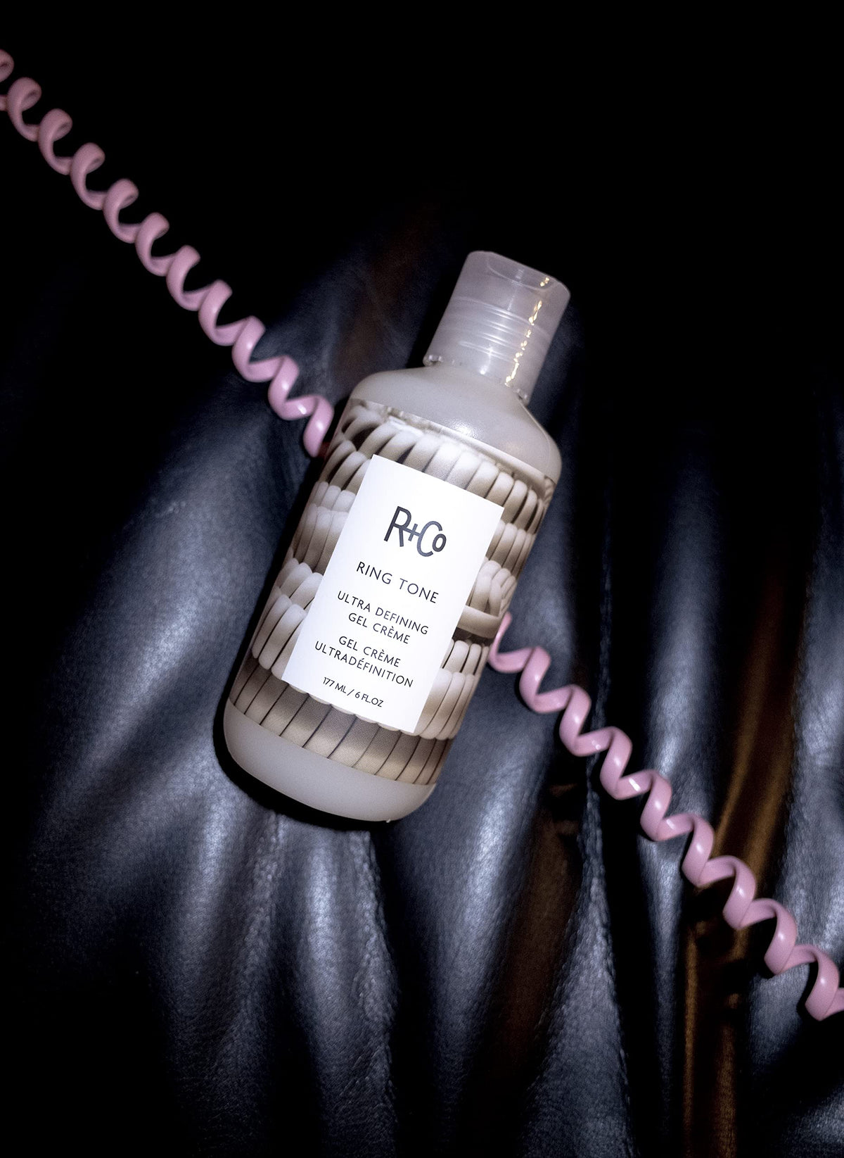 R+Co Ring Tone styled hair under diffuser demonstrating defined curls and volume