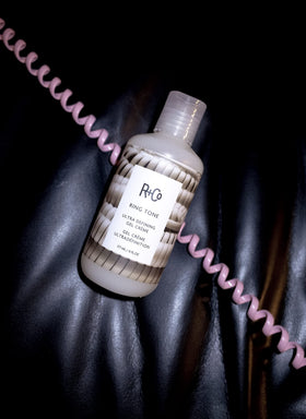 R+Co Ring Tone styled hair under diffuser demonstrating defined curls and volume