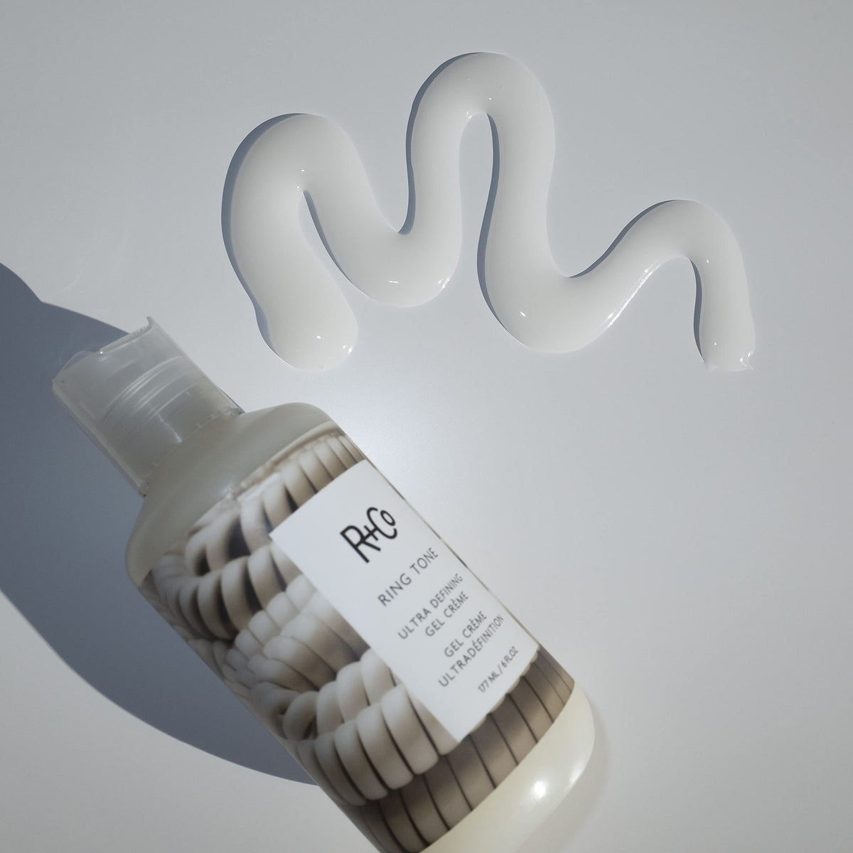 R+Co Ring Tone on model with beach waves showing defined, frizz-resistant curls