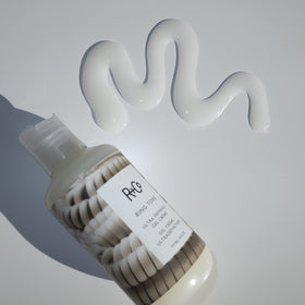 R+Co Ring Tone on model with beach waves showing defined, frizz-resistant curls