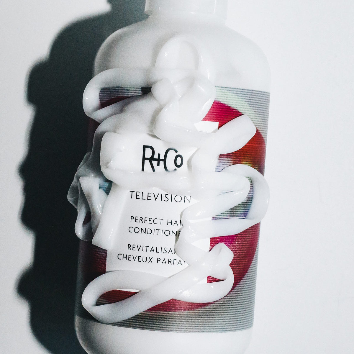 R+Co Television conditioner 1000ml beside common items to show scale