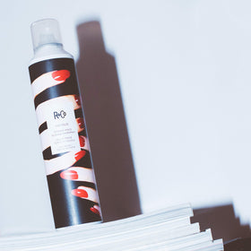 R+Co Vicious next to hand to show 9 oz scale and convenient salon-sized benefit