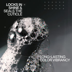 Redken bottle close-up highlighting pump and salon-grade design benefit