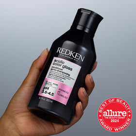 Redken 33.8 fl oz bottle next to common items to indicate scale and value