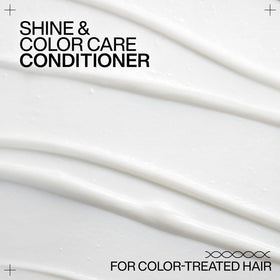 Redken conditioner on bathroom shelf in styled setting, showcasing salon shine