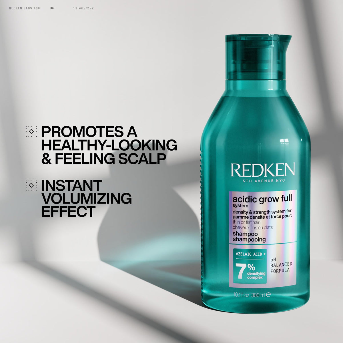 Redken bottle scale comparison in hand showing large 33.8 fl oz size benefit
