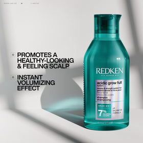 Redken bottle scale comparison in hand showing large 33.8 fl oz size benefit