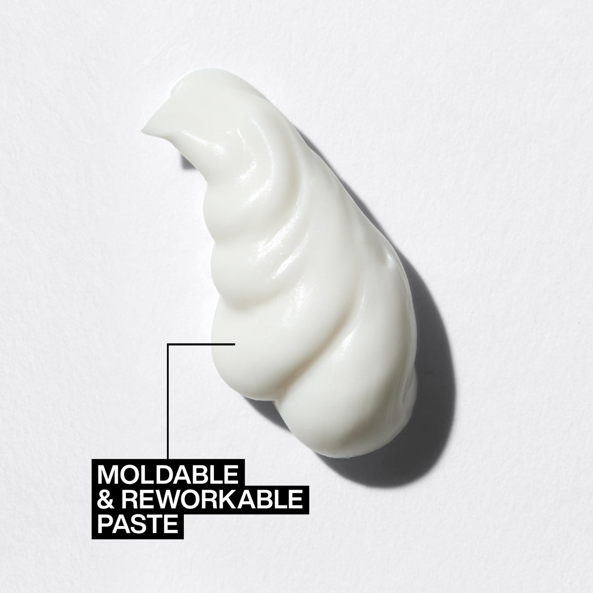 Redken paste rubbed into hands ready to apply for controlled, flexible styling