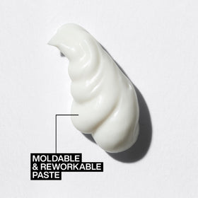 Redken paste rubbed into hands ready to apply for controlled, flexible styling