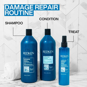 Redken Extreme Conditioner beside hand for scale shows generous 33.8 fl oz