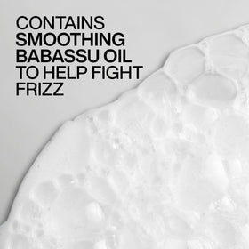 Redken Frizz Dismiss shampoo applied in shower for frizz control