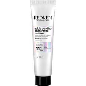 Redken bottle front view showing clear branding and repair benefit