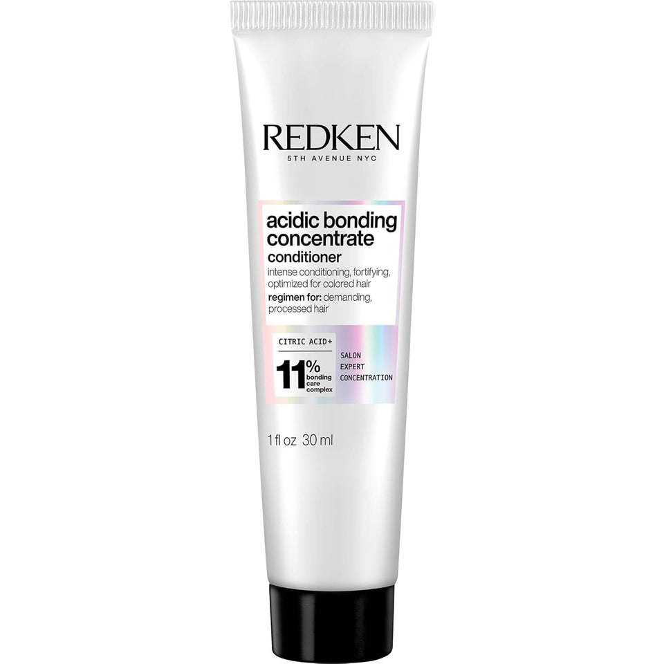 Redken bottle front view showing clear branding and repair benefit
