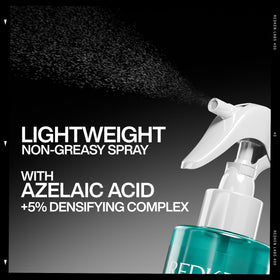 Redken bottle held in hand to show actual size and travel-friendly convenience