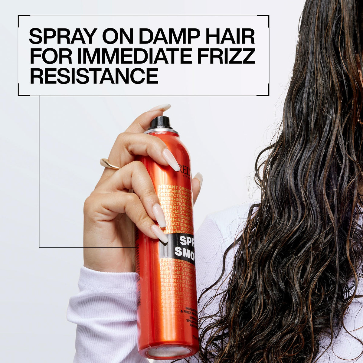 Redken spray smooth bottle held in hand showing compact travel size