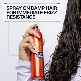 Redken spray smooth bottle held in hand showing compact travel size