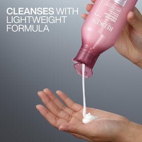 Redken shampoo applied to wet hair showing lightweight cleansing benefit