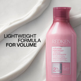 Redken Volume Injection Conditioner in a styling scene with blow-dryer showing salon-level volume benefit