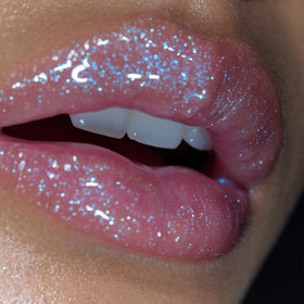 r.e.m. beauty on lips in studio lighting highlighting plump shine