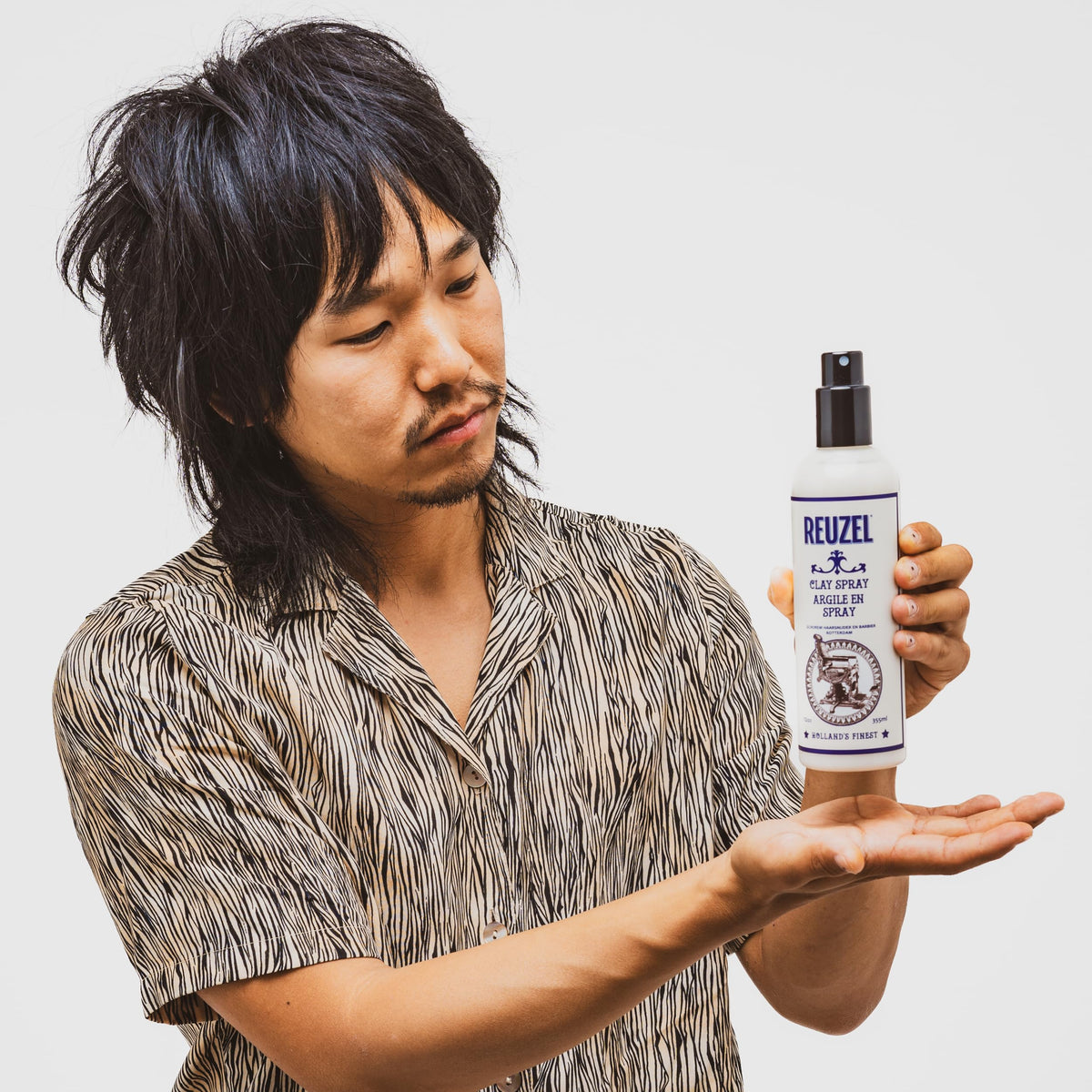 REUZEL used by barber in chair showing professional finish and quick styling benefit