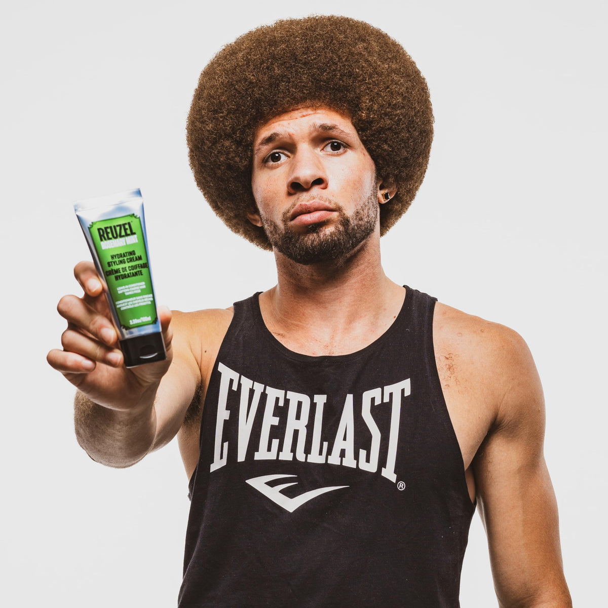 REUZEL cream on bathroom shelf in lifestyle scene conveying daily grooming routine