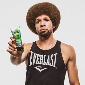 REUZEL cream on bathroom shelf in lifestyle scene conveying daily grooming routine