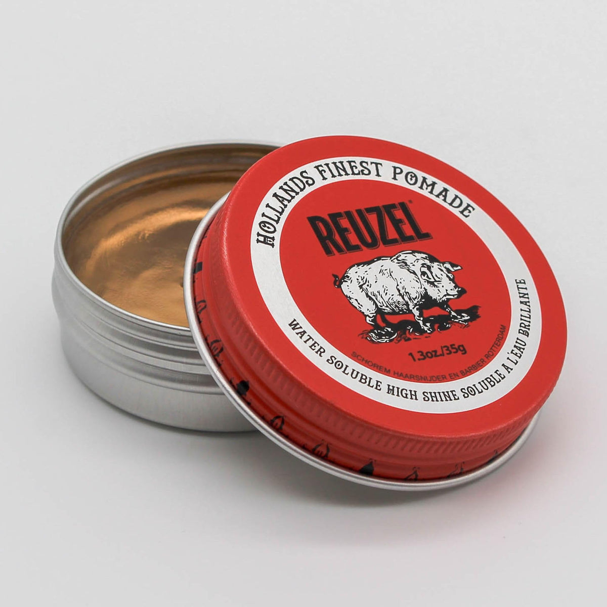 REUZEL Red Pomade creamy texture on fingers demonstrating smooth application benefit