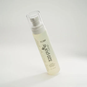 Rev320 bottle on bathroom shelf lifestyle shot conveying salon-quality daily care