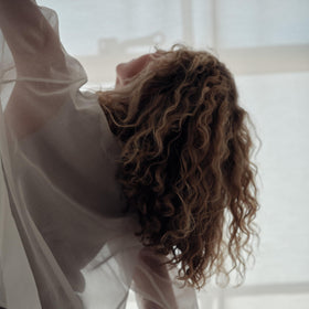REVERIE smoothing ends in a chignon highlighting sleek finish