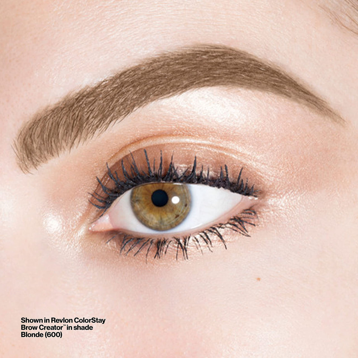 Revlon Brow Creator next to a coin for scale, compact travel-friendly brow tool