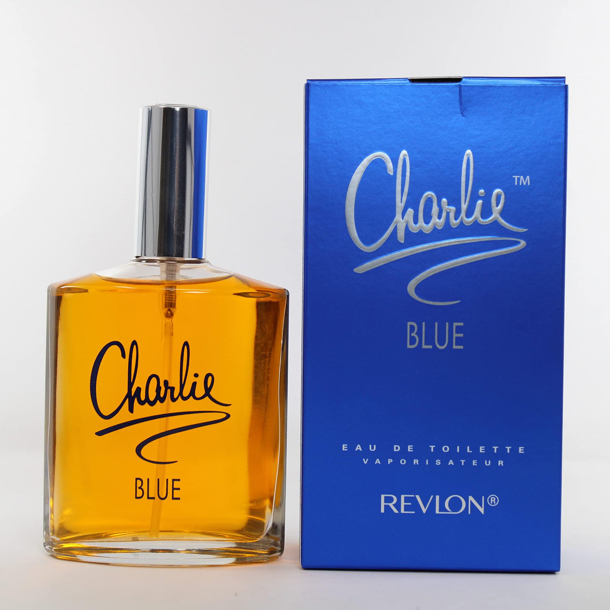 REVLON Charlie Blue held in hand demonstrating 100 ml travel-friendly convenience