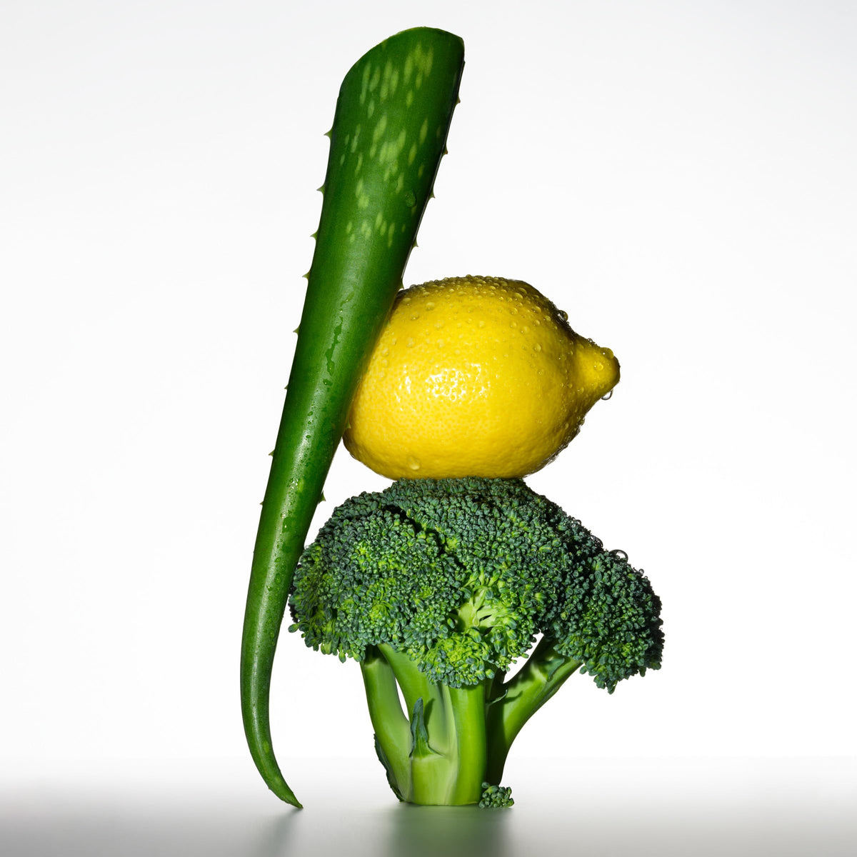 Botanical ingredients citrus aloe broccoli beside Revlon ColorStay highlighting protective blend