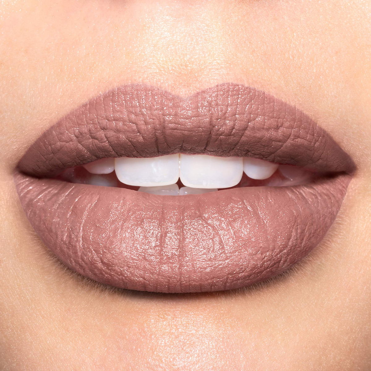 Revlon shade Untold Stories swatch on arm showing creamy matte payoff benefit true-to-tube color