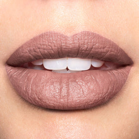 Revlon shade Untold Stories swatch on arm showing creamy matte payoff benefit true-to-tube color