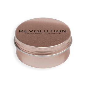 Revolution Balm Glow held in hand for size comparison and travel-friendly convenience