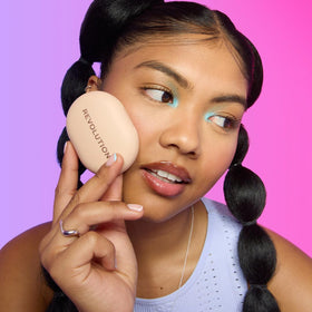 Revolution beauty powder pops compact in hand showing pocket-friendly size for on-the-go mattifying benefit